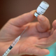 A nurse prepares a syringe with a dose of the Pfizer-BioNTech vaccine